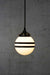 Hand painted opal glass ball pendant light with two stripes hung on black twisted cord