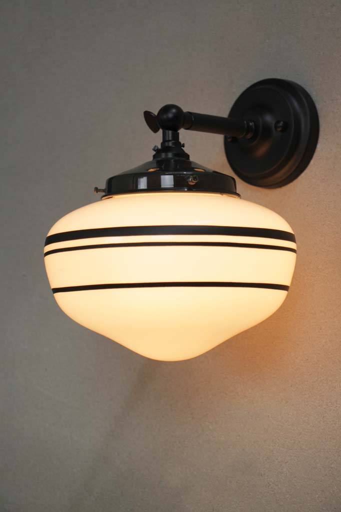 Black wall light with small opal three stripe shade