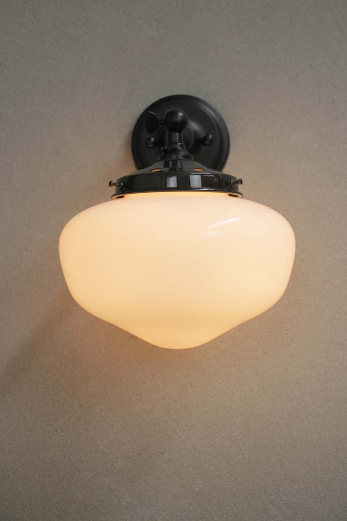 Black wall light with small plain shade