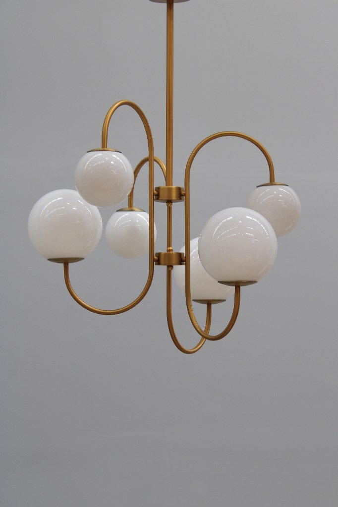 Six light chandelier in a gold finish switched off