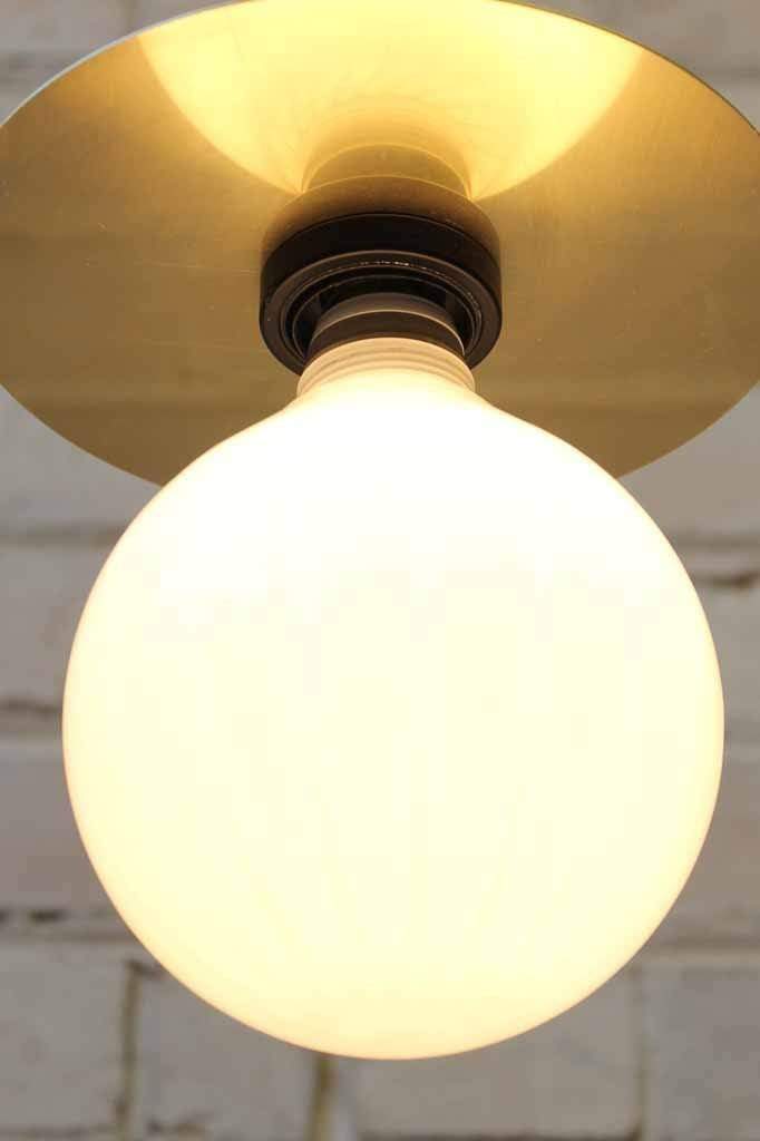 brass light with opal light bulb