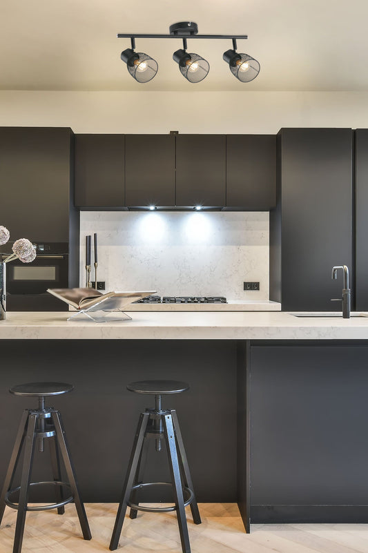 Three light spotlight above marble countertop