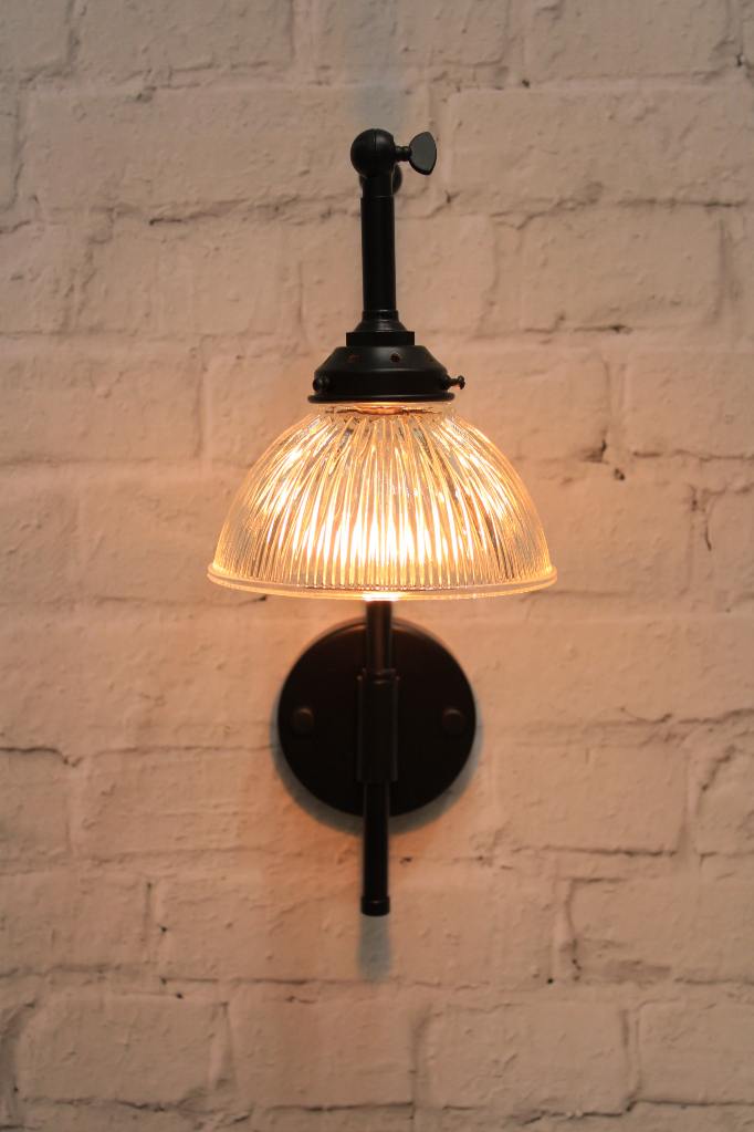 Black wall light with holophane glass shade