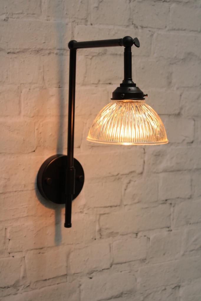 Black wall light with holophane glass shade