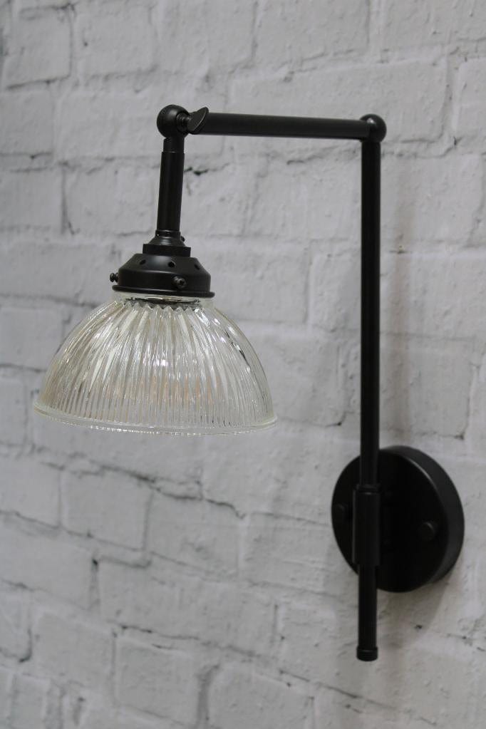 Black wall light with holophane glass shade