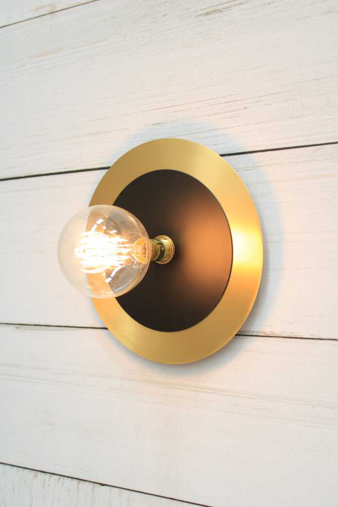 Large brass with small black disc wall light