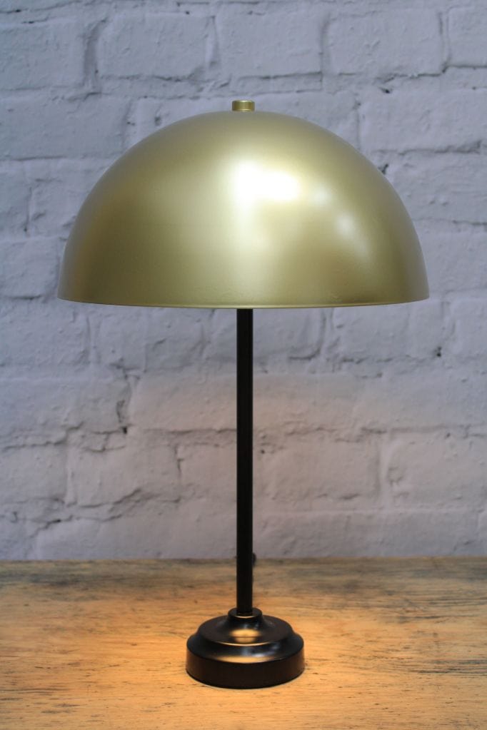 Table lamp with gold/brass dome shade and black base