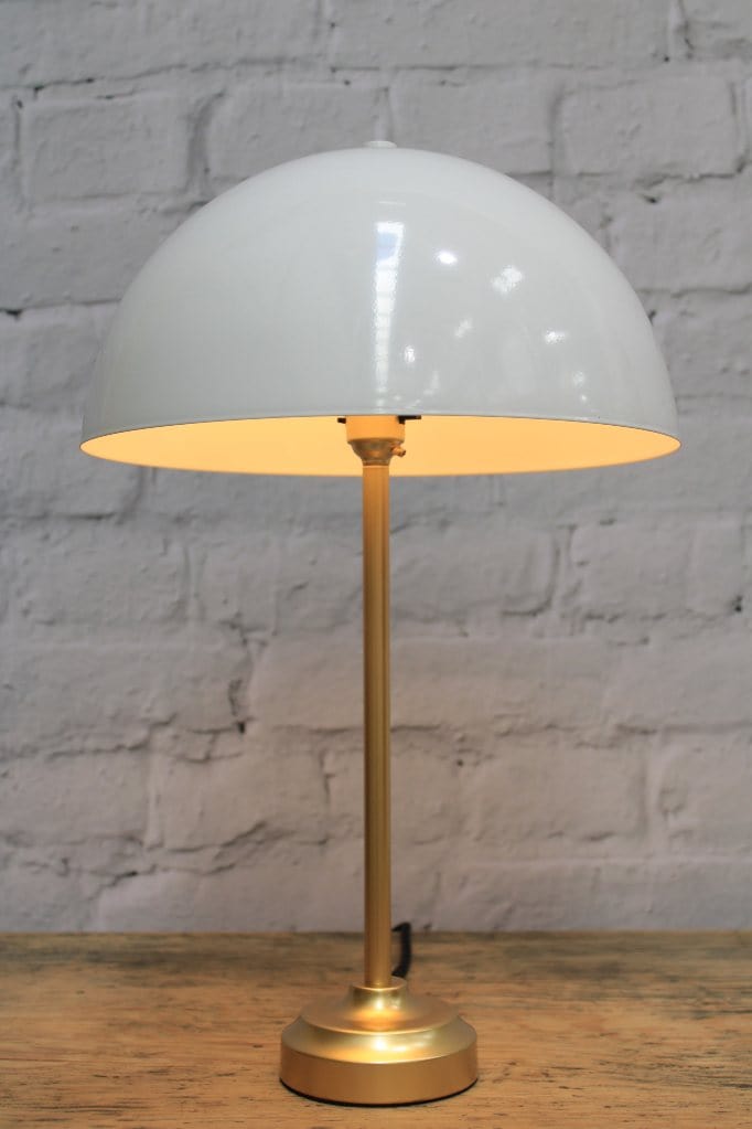 Table lamp with white dome shade and gold/brass base