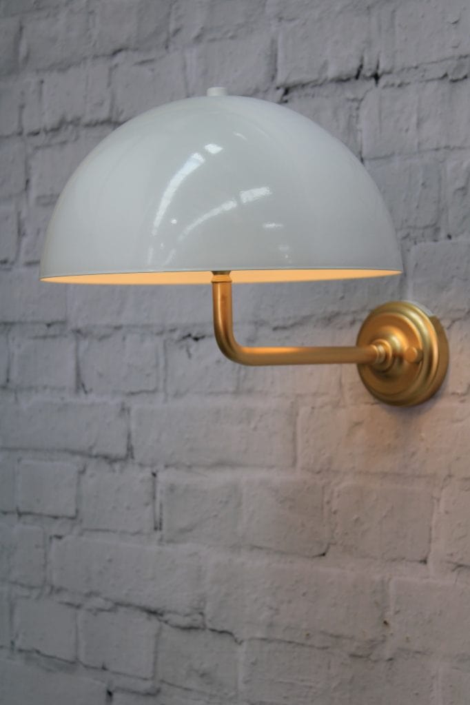 Gold/brass wall sconce with white shade