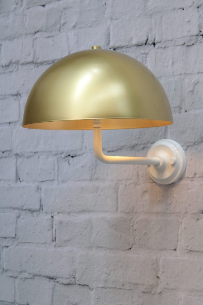 White wall sconce with gold/brass shade