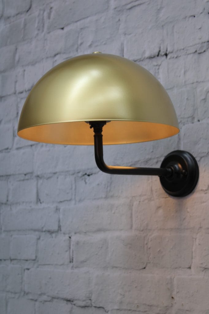 Black wall sconce with gold/brass shade