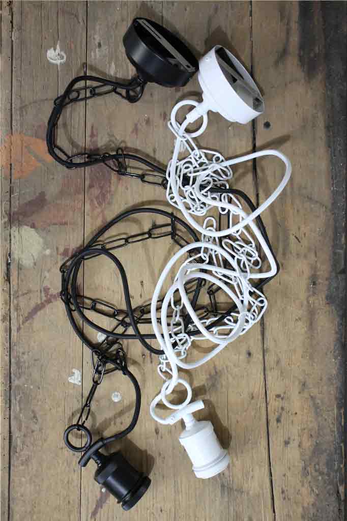 black and white chain pendant cords laying on a timber table