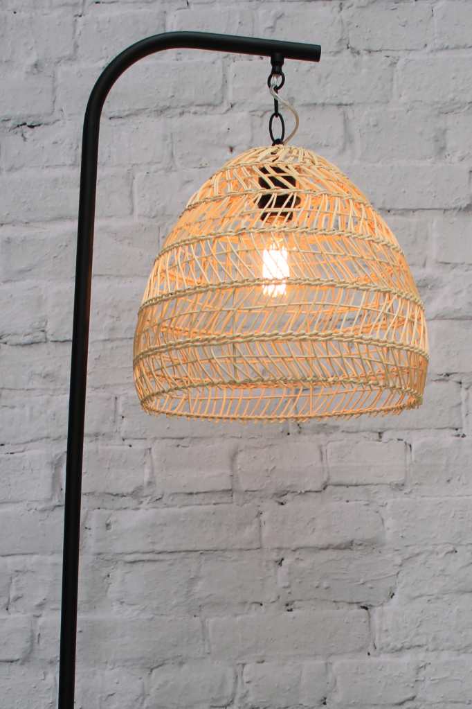 Black floor lamp with suspended rattan shade