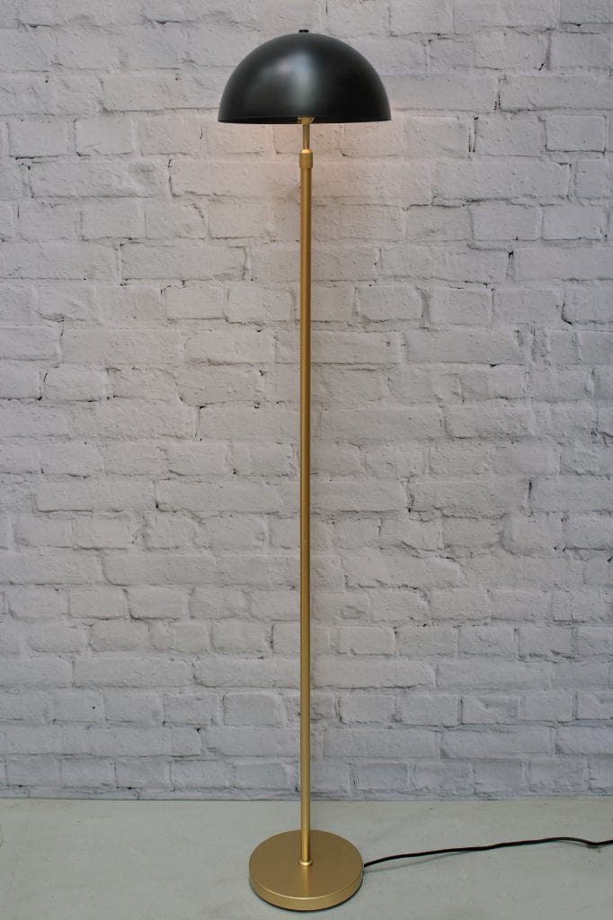 Gold/brass floor lamp with medium black shade