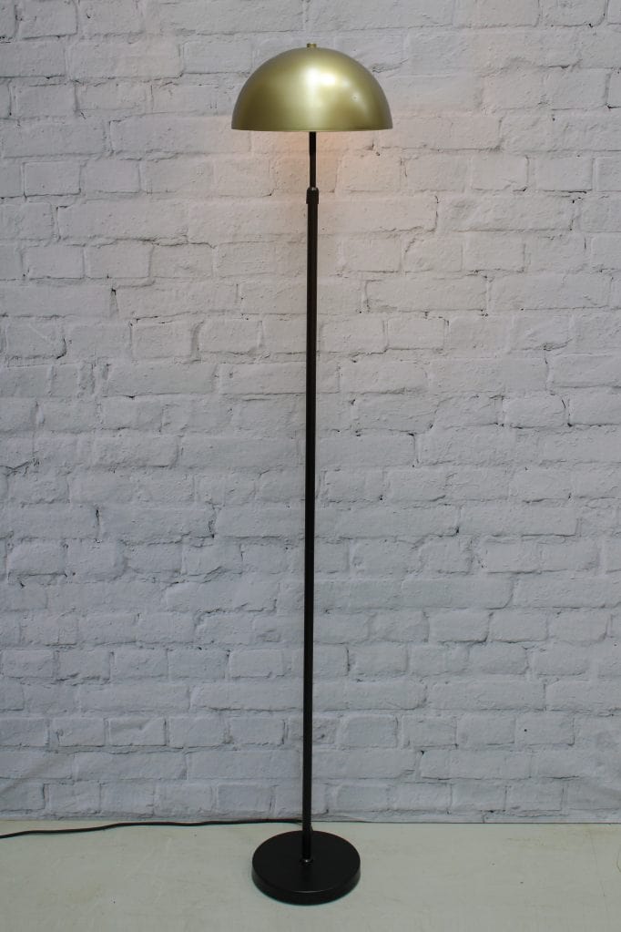 Black floor lamp with medium gold/brass shade