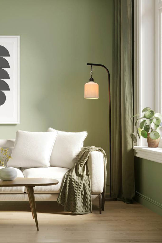 Ceramic floor lamp within a living room setting. 