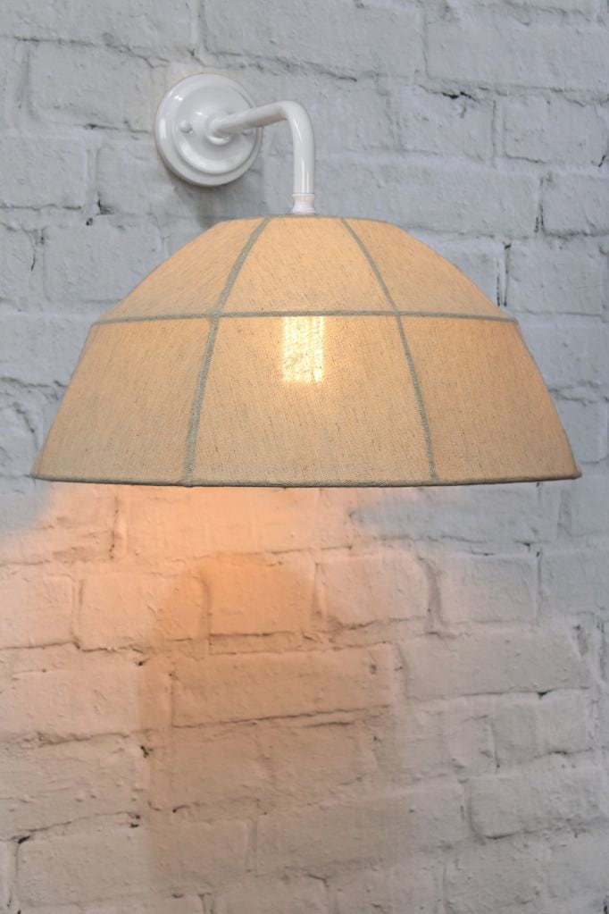 White wall light with natural linen shade