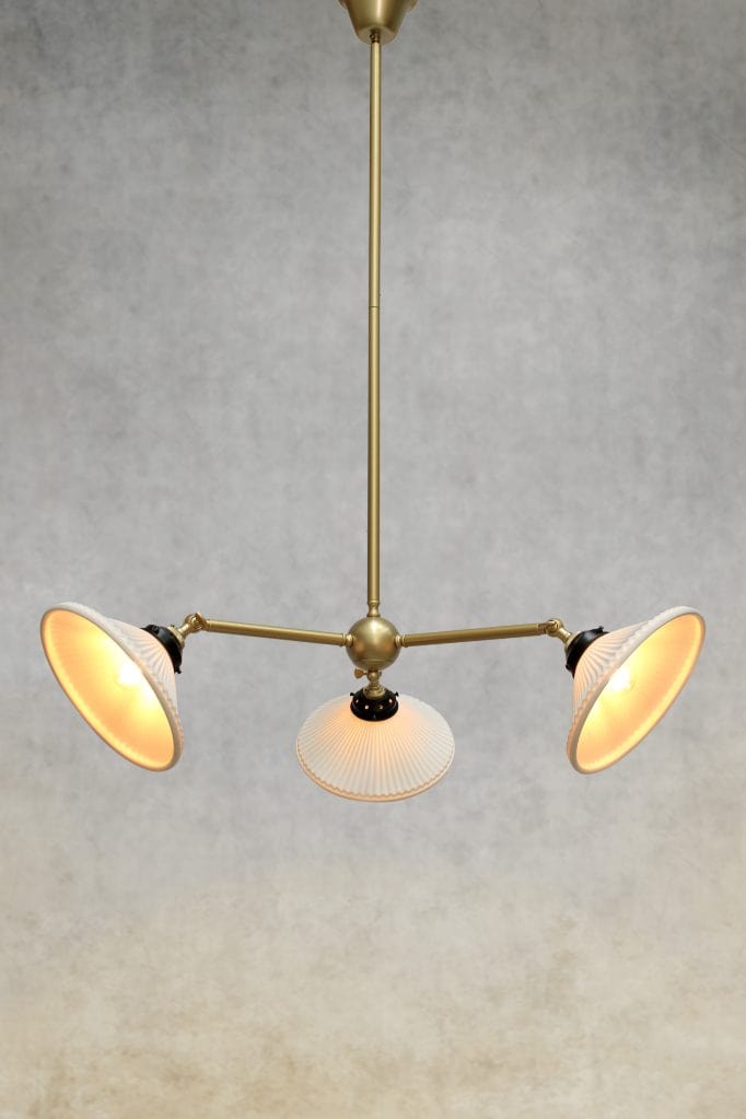 Three light chandelier in gold/brass finish with ceramic shades