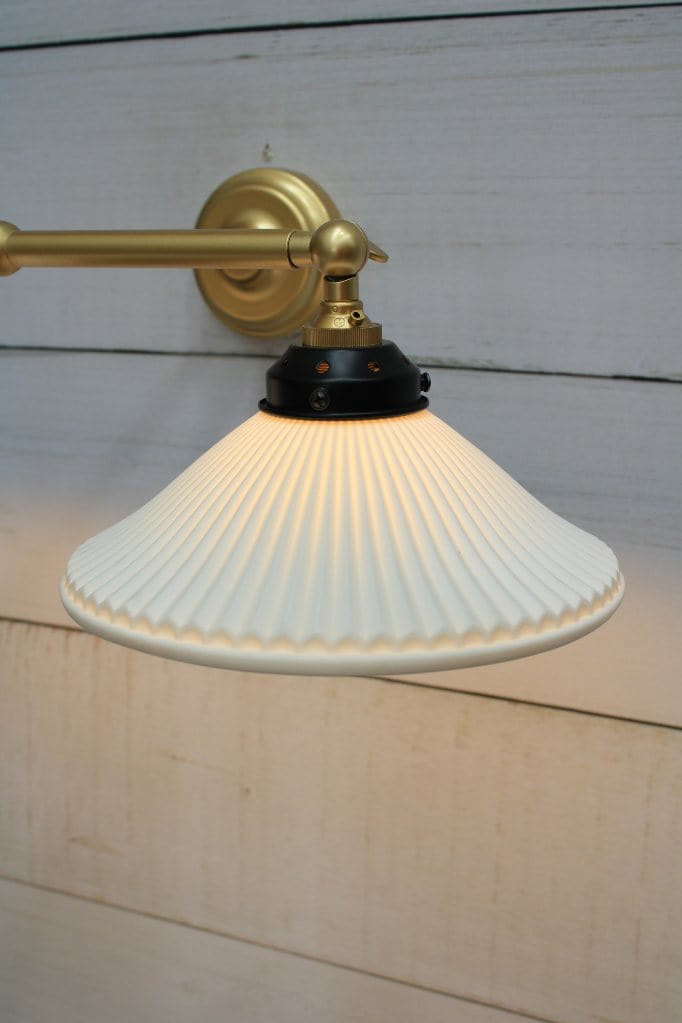 Double arm wall light with gold/brass finish and ceramic shades