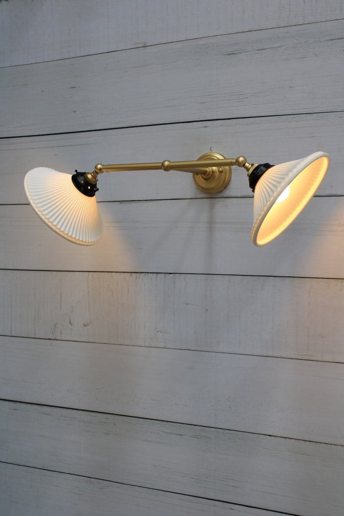 Double arm wall light with gold/brass finish and ceramic shades