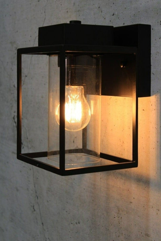 Metal wall light with inner glass tube shade