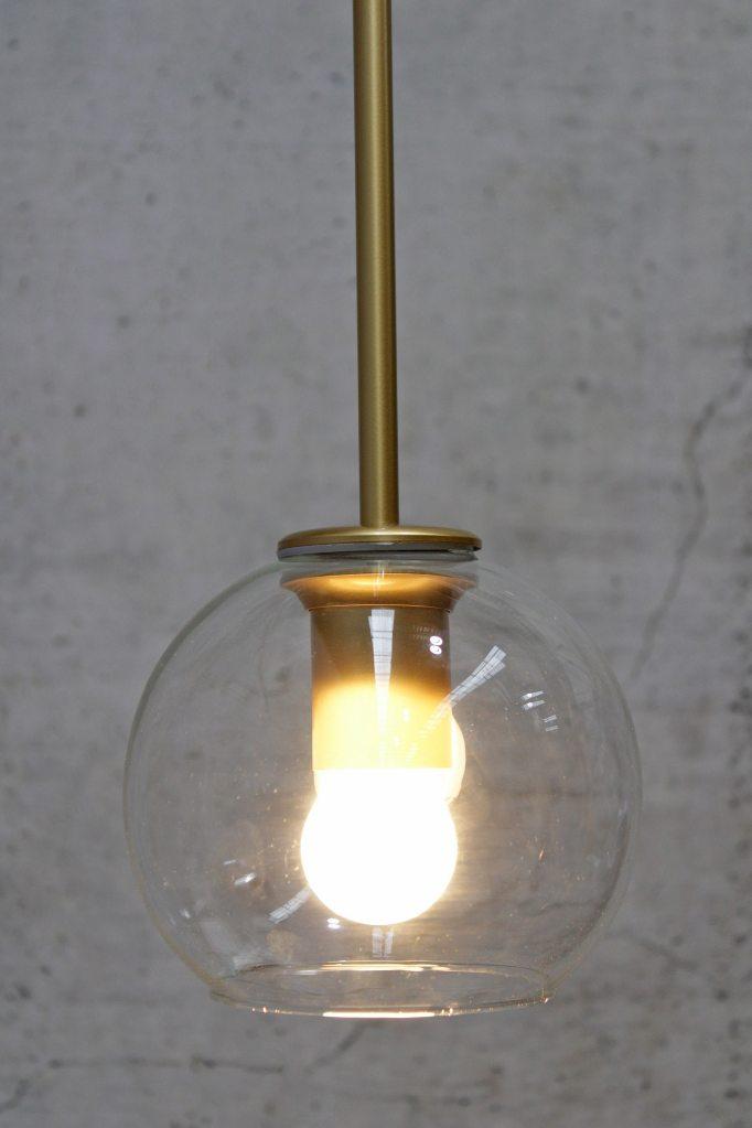 Gold pendant light with opal bulb