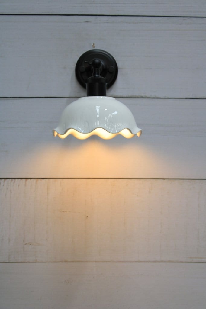 Front view of wall light with black short arm. 