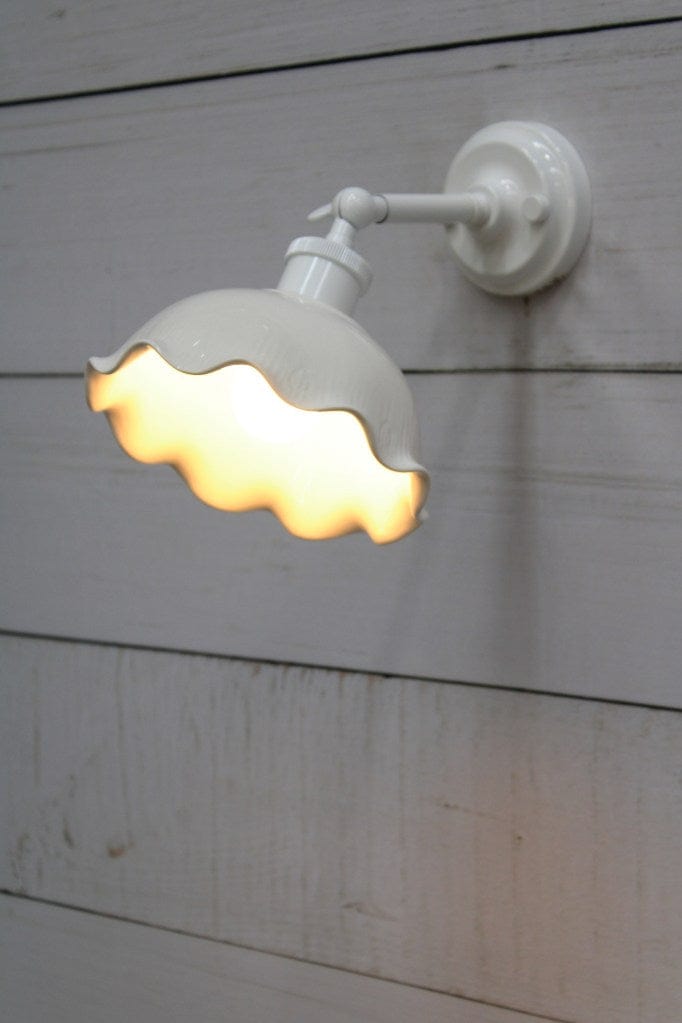 Wall light with white short arm extended. 