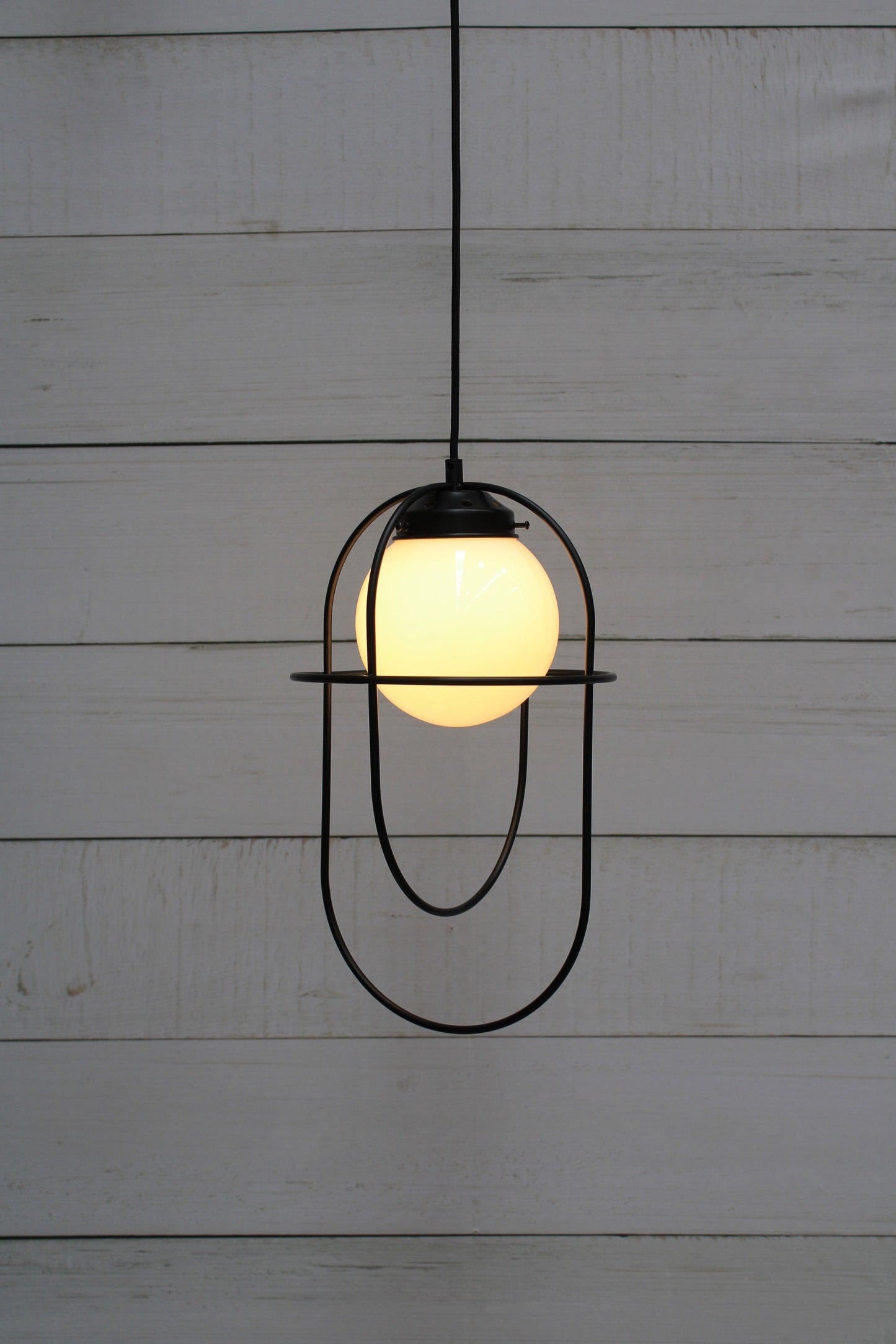 Pendant light with opal glass shade and matt black metalware