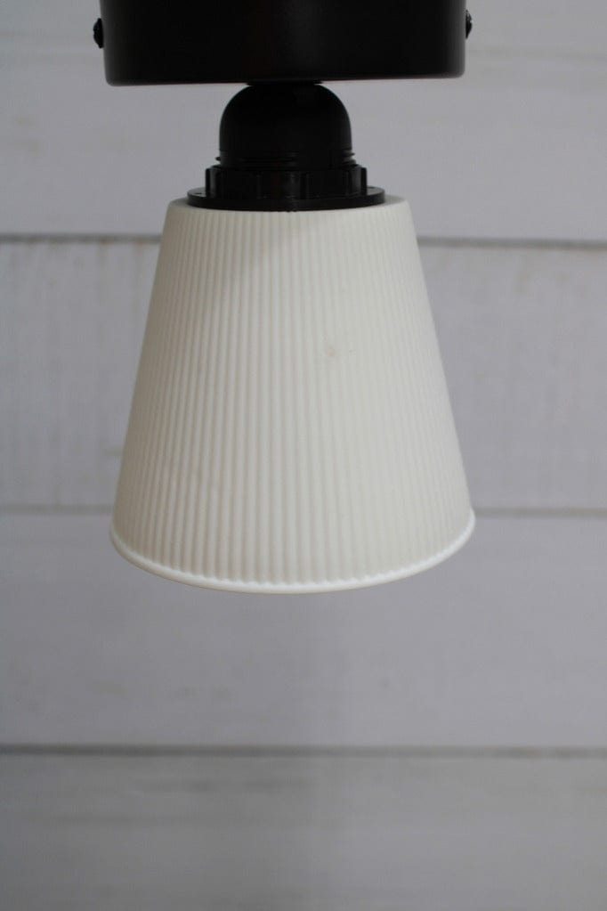 Ceiling light with black base and small ceramic shade