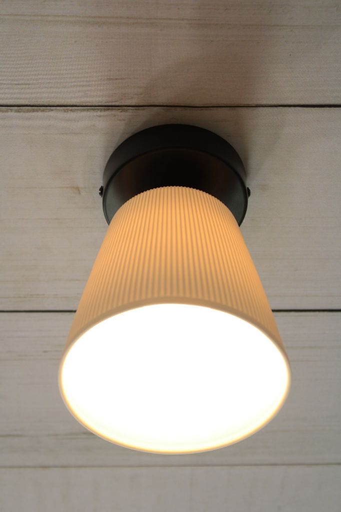 Ceiling light with black base and large ceramic shade