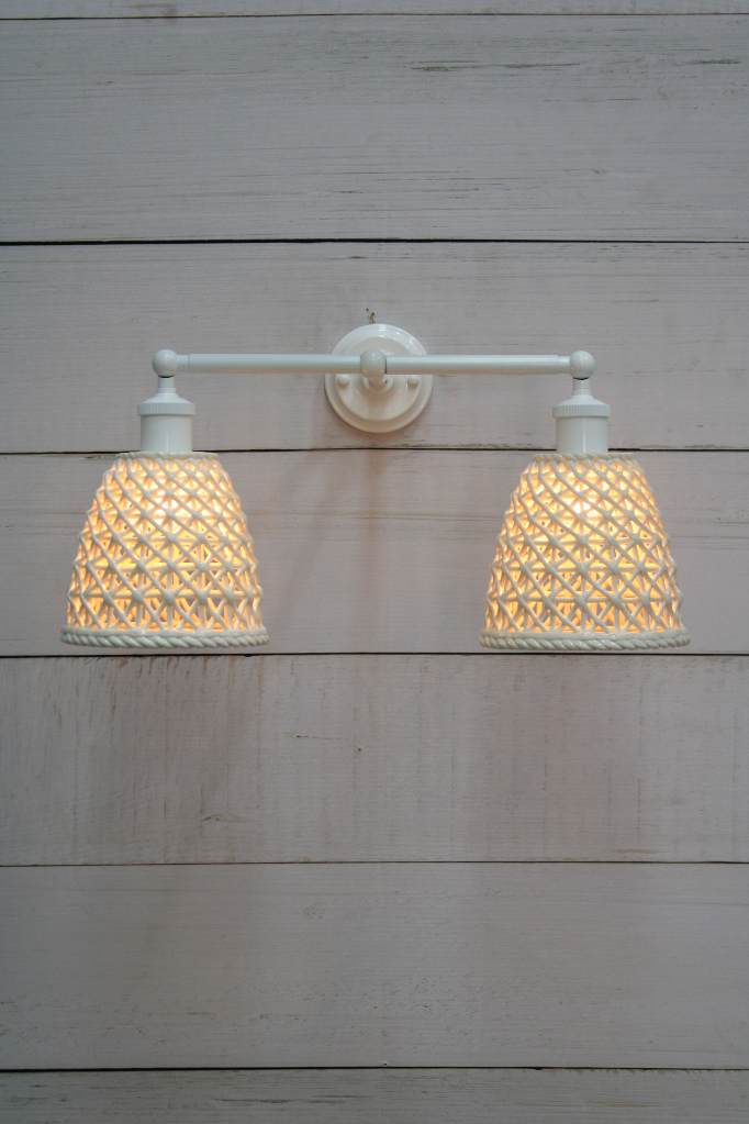 Front view of tall Milan ceramic shades with white swivel arm. 