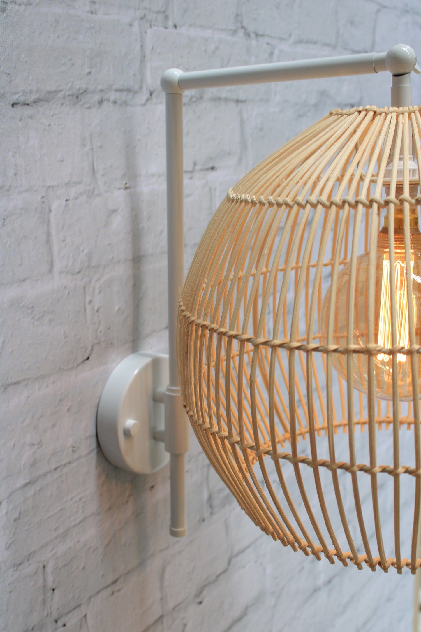 rattan shade on white sconce