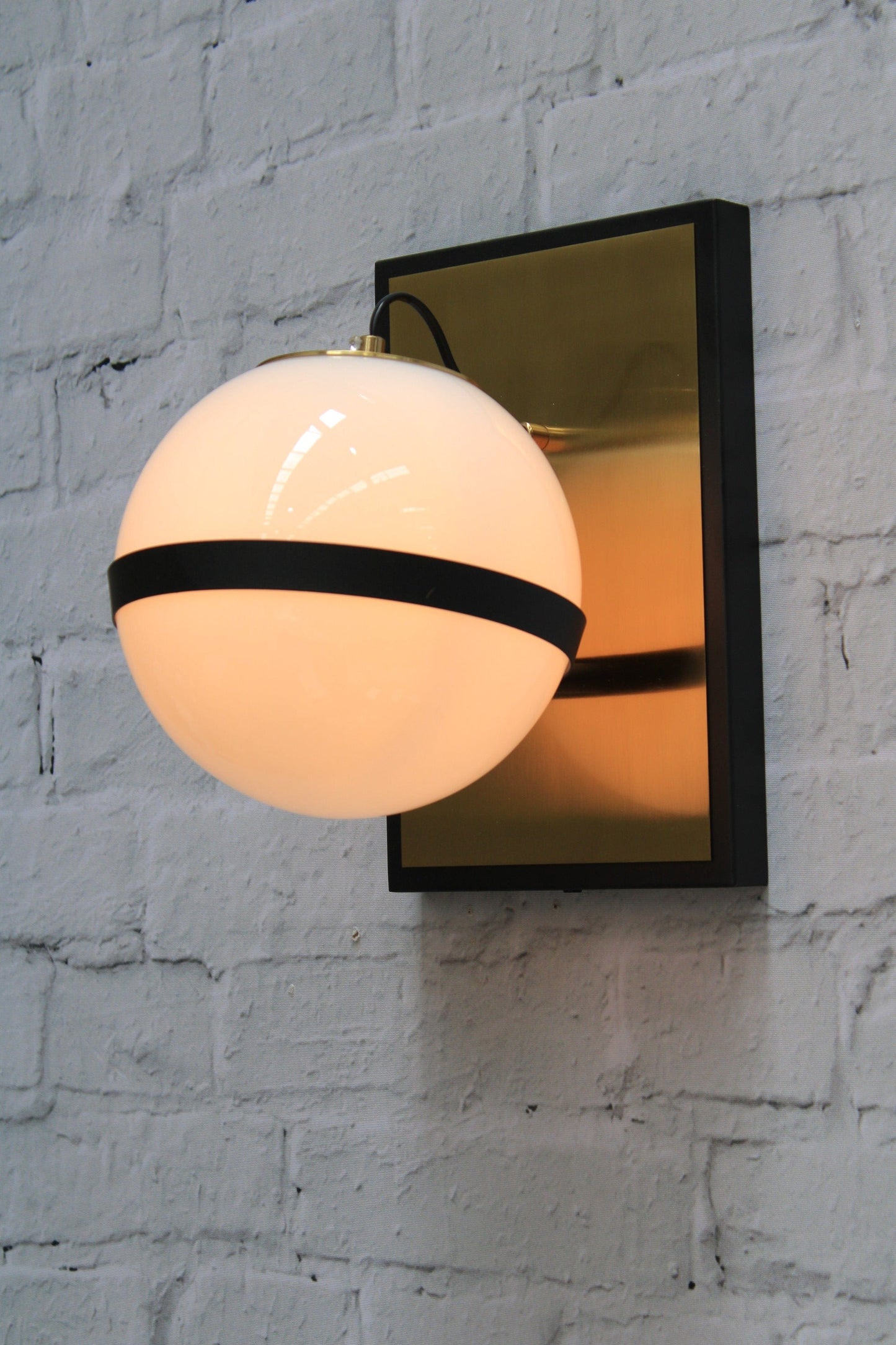 Opal Glass ball wall light with brass mount