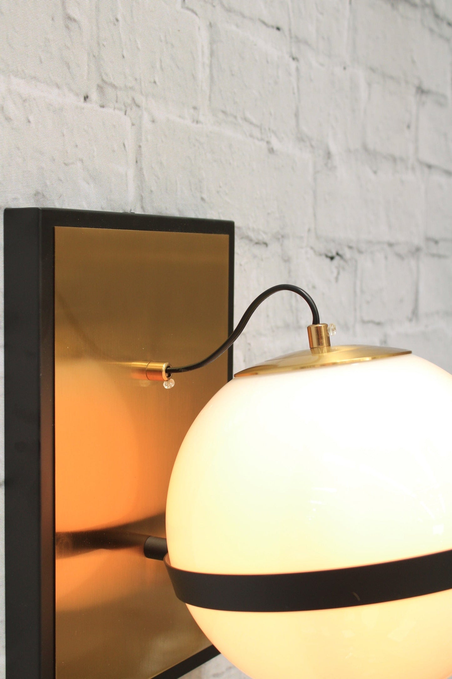 Glass ball wall light with brass mount