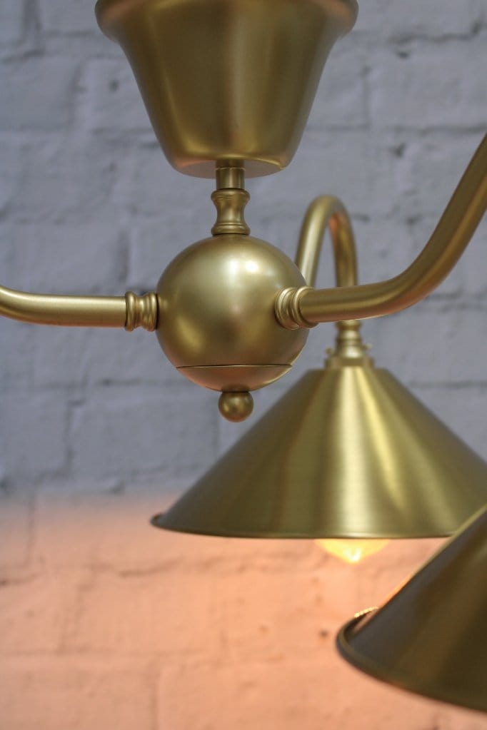 Industrial flush mount light in gold finish close up on centrepiece