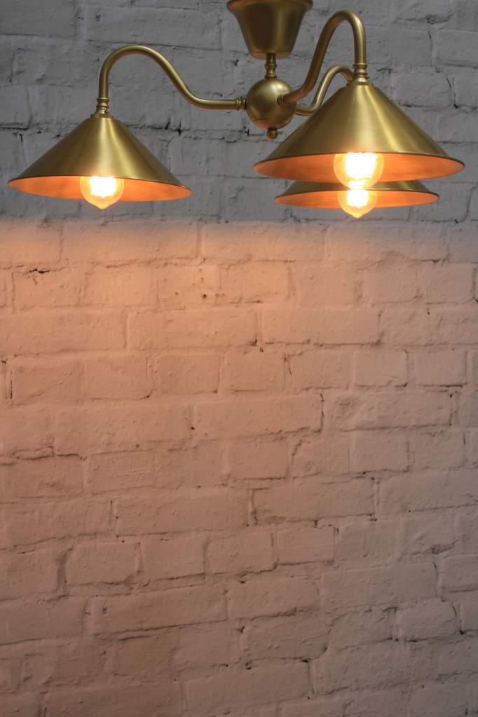 Industrial flush mount light in gold finish with bright brass shades