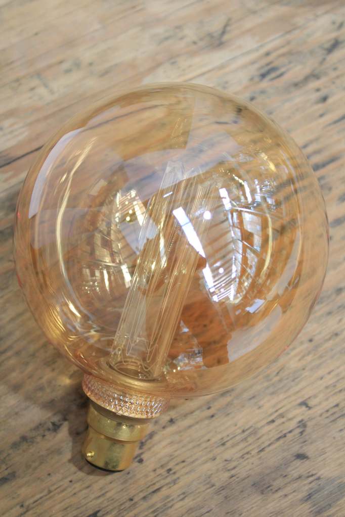 Round amber bulb with laser-cut filament