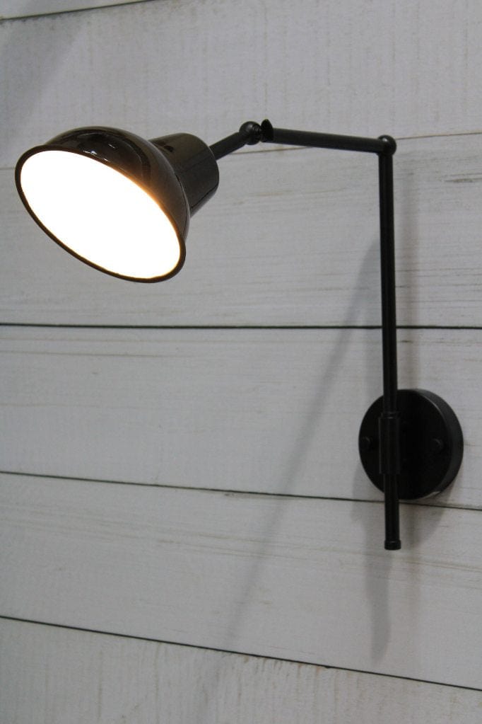 Black wall sconce with black and white shade