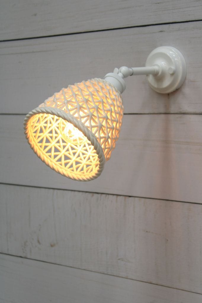 White wall light with tall ceramic shade