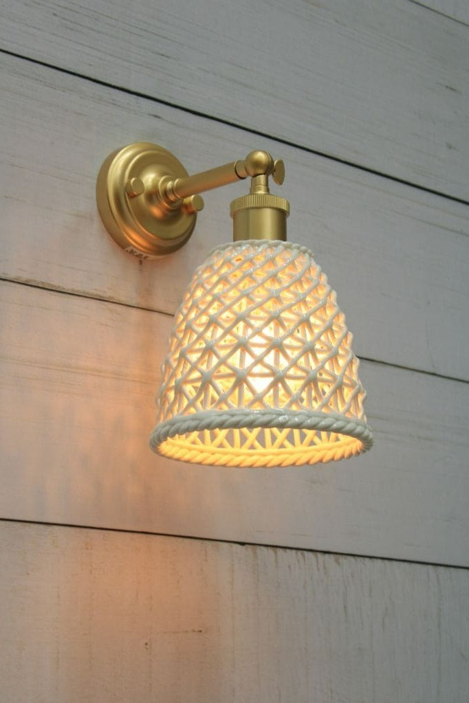 Gold/brass wall light with tall ceramic shade