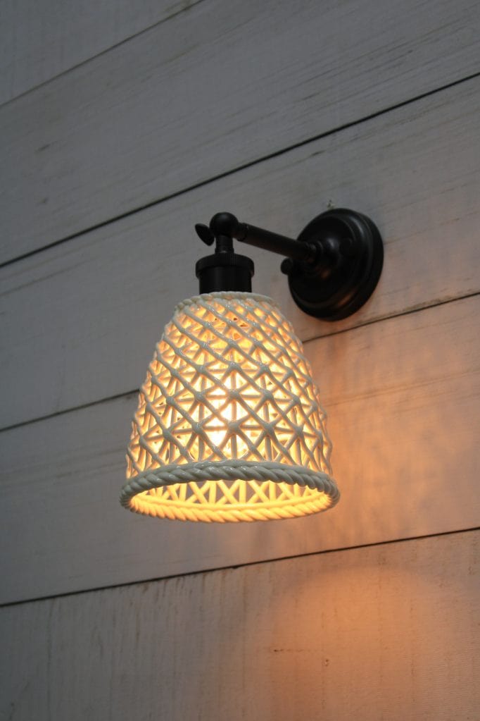 Black wall light with tall ceramic shade