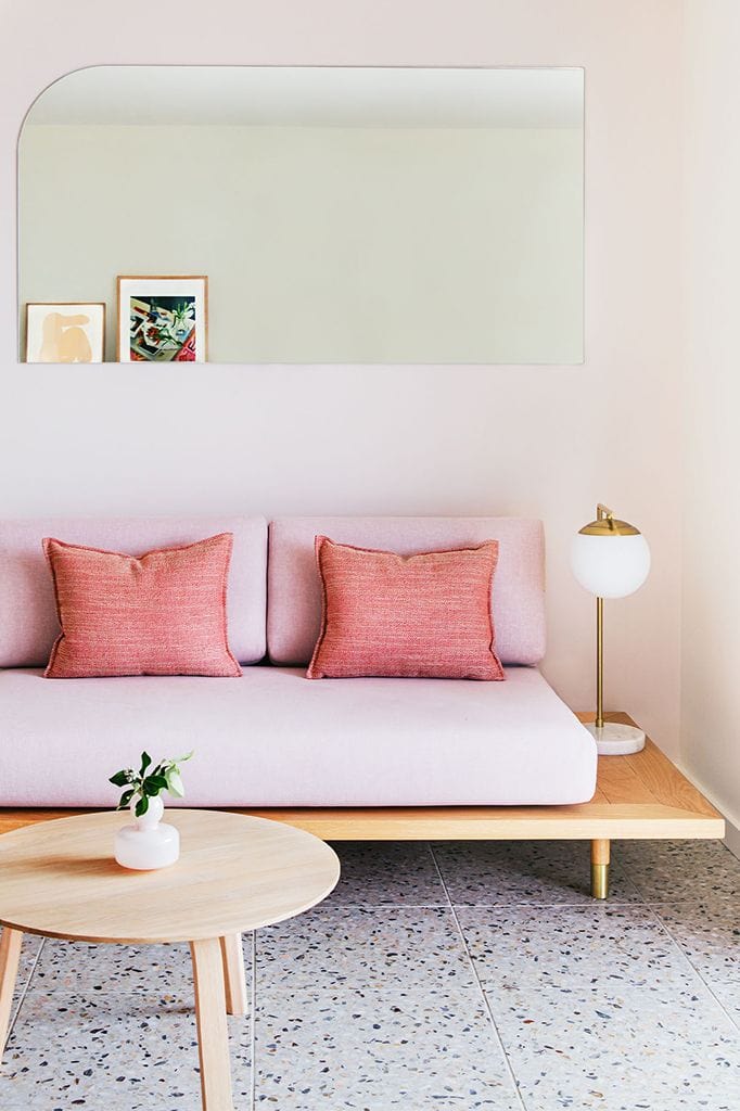 Brass light with opal shade and marble base in a living room setting 