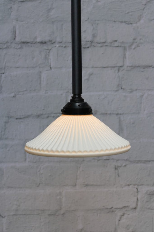 Ceramic shade on black pole pendant light