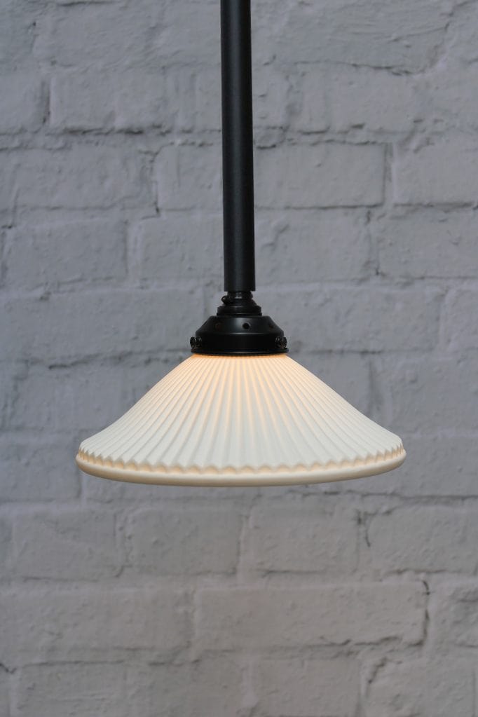 Ceramic shade on black pole pendant light