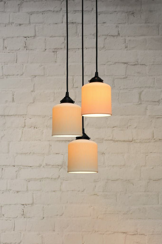 Three light pendant with ceramic shades and round cords