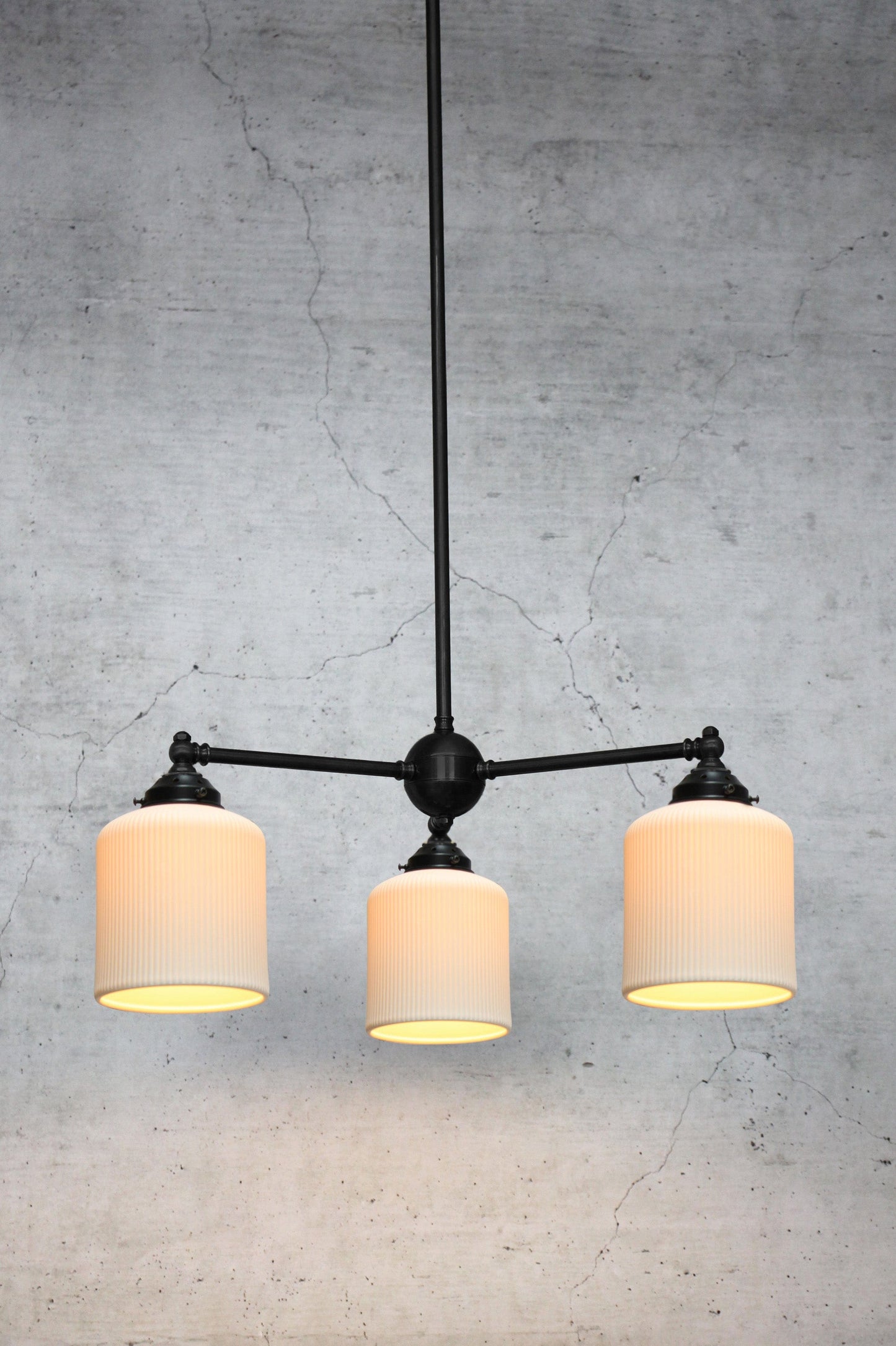 Three light ceramic chandelier on black brass base