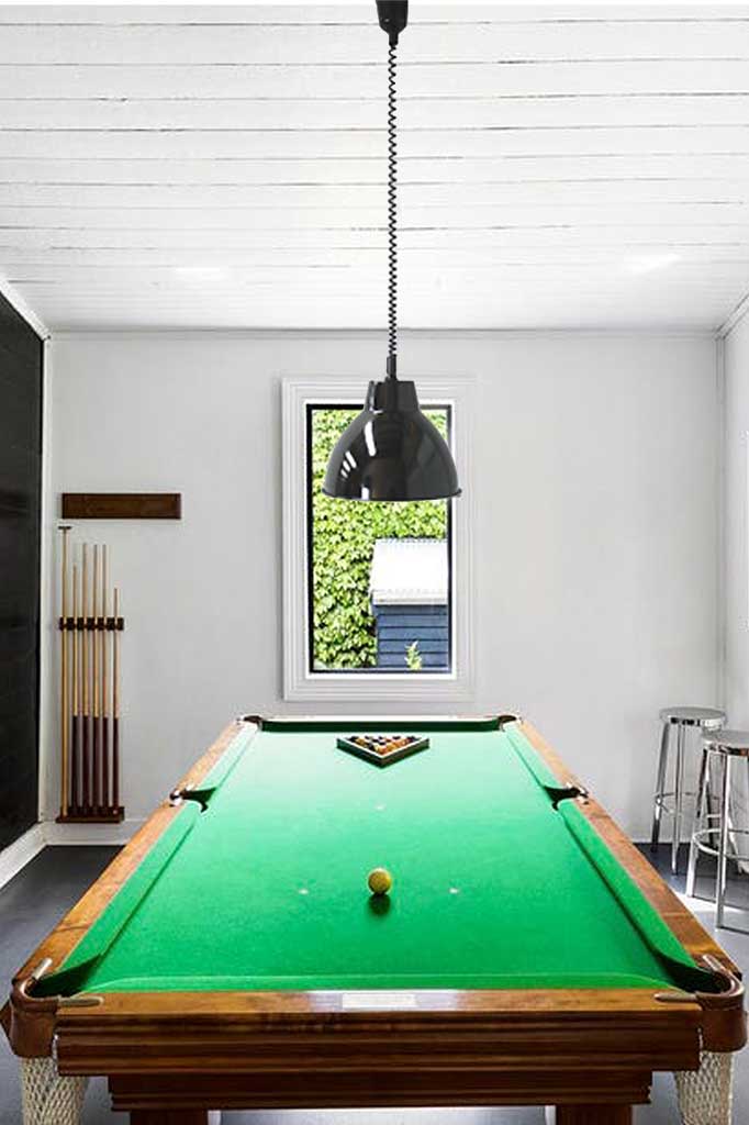 adjustable black pendant cords over pool table.