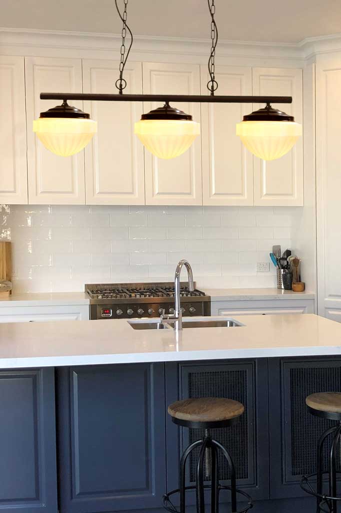 Riviera Glass Swing Pendant Light over kitchen island.