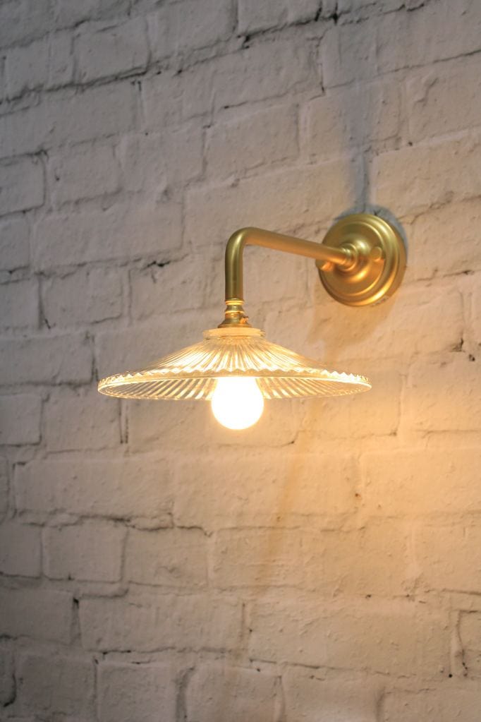 Glass wall light with gold/brass wall sconce